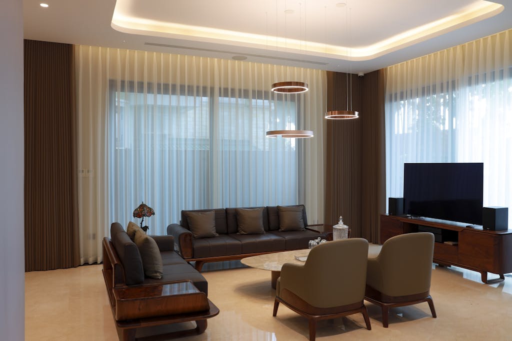 A spacious, elegant living room with modern furniture and stylish lighting.